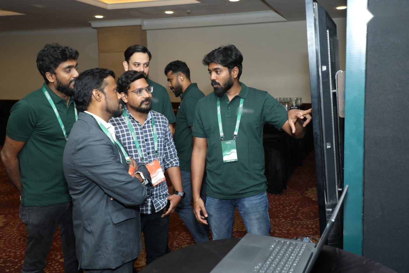 Chanakian pointing at a screen during a live demo