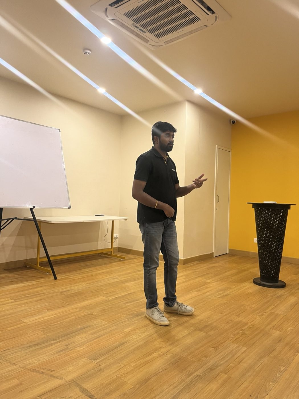Chanakian standing and speaking in a training room